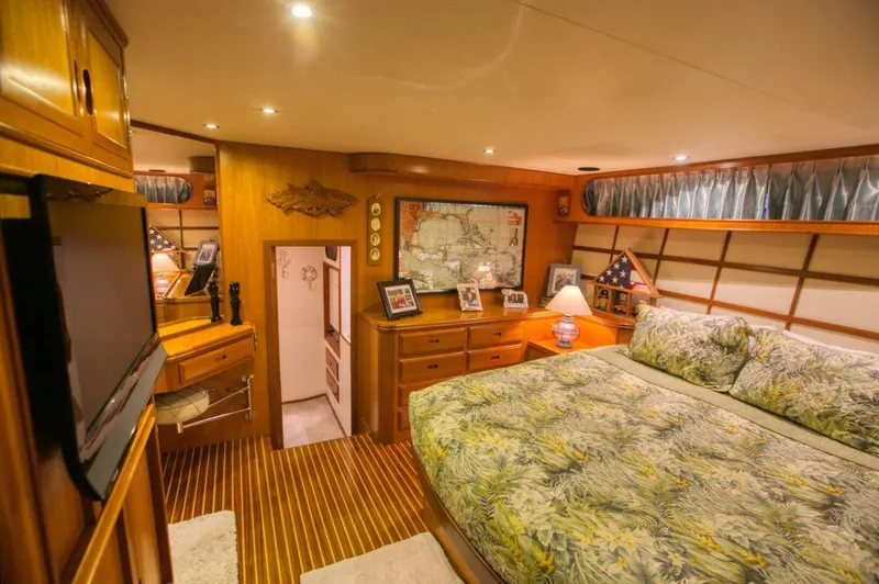 The Cotton Picker Yacht Photos Pics Luxurious bedroom interior of 2000 Ocean Alexander 610 Pilothouse yacht with elegant wood finishes.
