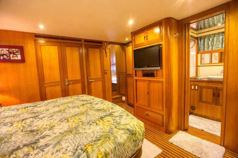 The Cotton Picker Yacht Photos Pics Luxurious cabin interior of 2000 Ocean Alexander 610 Pilothouse yacht with wood paneling and TV.