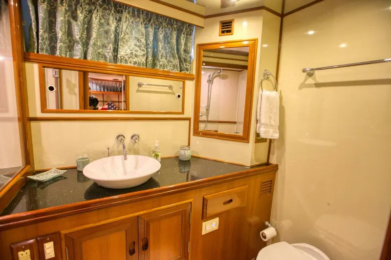 The Cotton Picker Yacht Photos Pics Luxurious bathroom in 2000 Ocean Alexander 610 Pilothouse yacht with elegant wood accents.