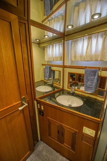 The Cotton Picker Yacht Photos Pics Luxurious bathroom in 2000 Ocean Alexander 610 Pilothouse yacht with wood cabinetry and modern fixtures.