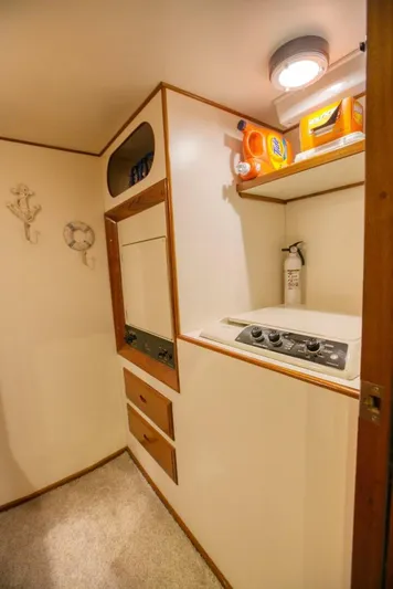 The Cotton Picker Yacht Photos Pics Laundry area in 2000 Ocean Alexander 610 Pilothouse yacht with washer, dryer, and storage.
