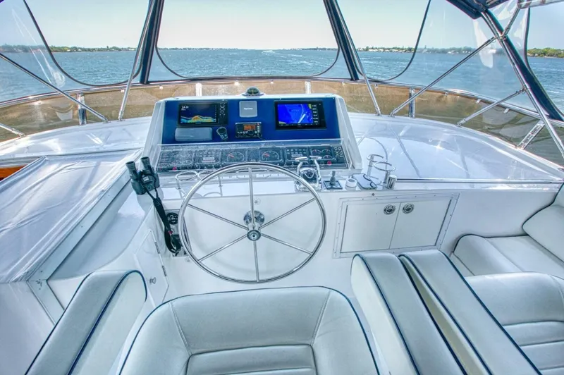 The Cotton Picker Yacht Photos Pics Pilothouse of 2000 Ocean Alexander 610 yacht with steering wheel and navigation equipment.