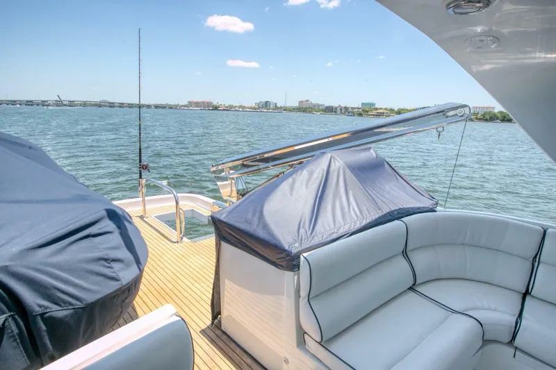 The Cotton Picker Yacht Photos Pics Luxurious Ocean Alexander 610 Pilothouse yacht deck with seating, overlooking serene waters.