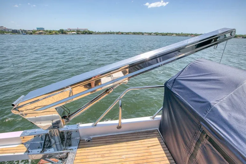 The Cotton Picker Yacht Photos Pics Ocean Alexander 610 Pilothouse yacht deck with polished metal railing, overlooking calm waters.