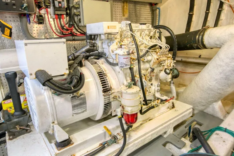 The Cotton Picker Yacht Photos Pics Engine room of 2000 Ocean Alexander 610 Pilothouse yacht, showcasing mechanical components.