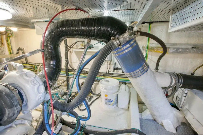 The Cotton Picker Yacht Photos Pics Engine room of 2000 Ocean Alexander 610 Pilothouse with hoses and equipment.