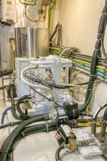 The Cotton Picker Yacht Photos Pics Engine room of 2000 Ocean Alexander 610 Pilothouse with mechanical equipment and wiring.