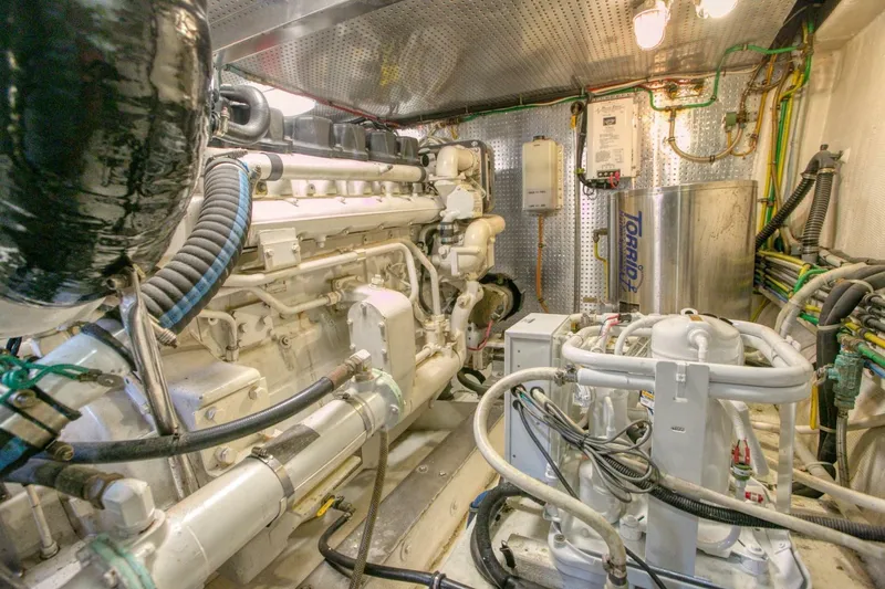 The Cotton Picker Yacht Photos Pics Engine room of 2000 Ocean Alexander 610 Pilothouse yacht, showcasing machinery and equipment.