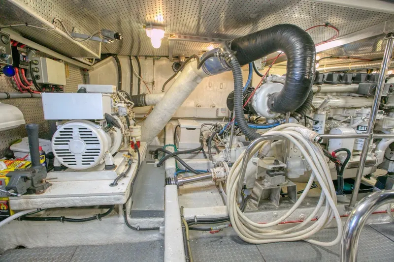 The Cotton Picker Yacht Photos Pics Engine room of 2000 Ocean Alexander 610 Pilothouse yacht, featuring mechanical equipment and wiring.