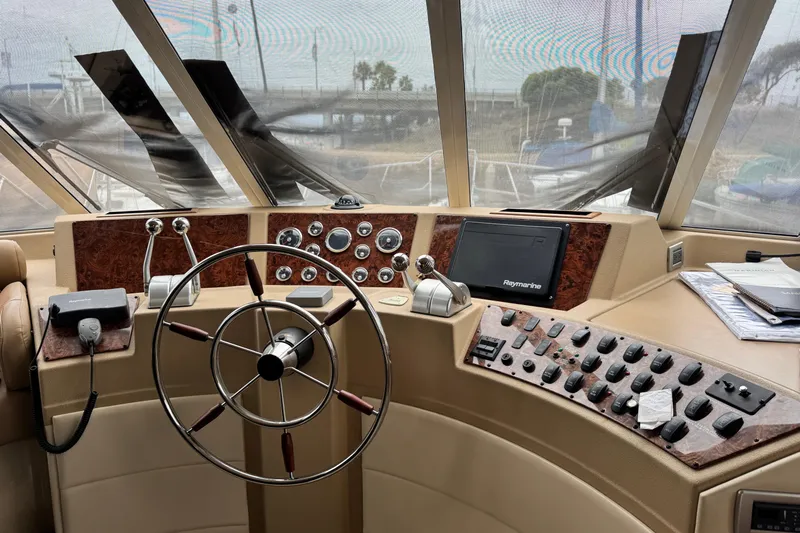  Yacht Photos Pics Pilothouse interior of 2006 Meridian 490, featuring steering wheel and control panel.