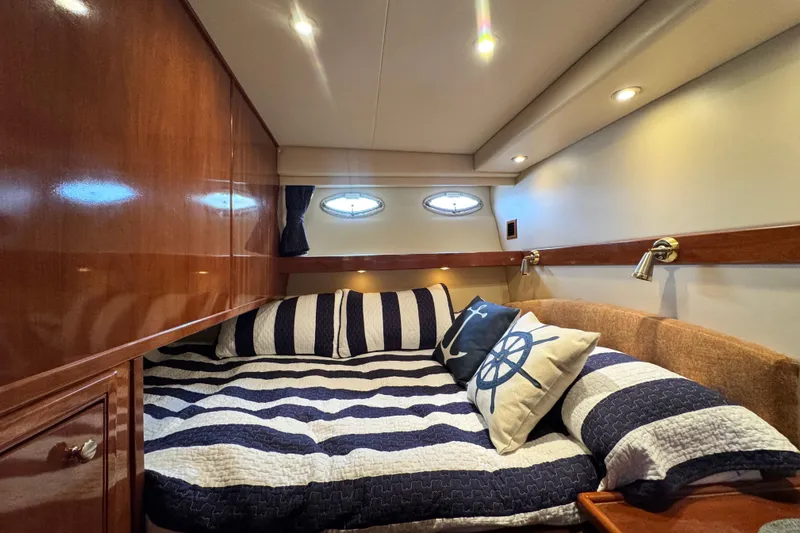  Yacht Photos Pics Luxurious cabin interior of 2006 Meridian 490 Pilothouse yacht with nautical-themed bedding.