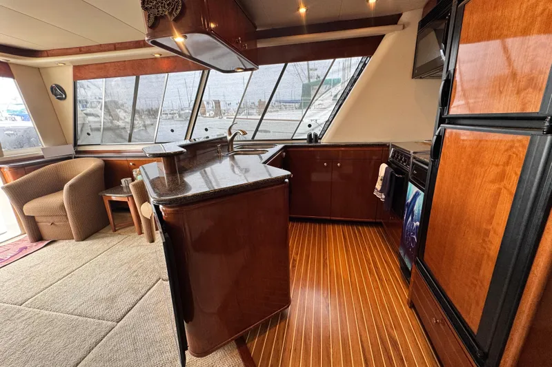  Yacht Photos Pics Luxurious 2006 Meridian 490 Pilothouse interior with elegant wood finishes and modern kitchen amenities.