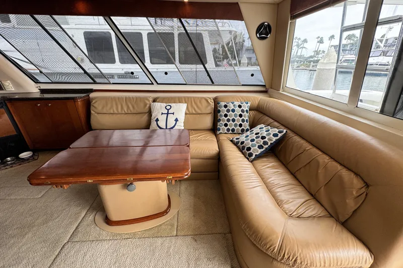  Yacht Photos Pics Luxurious interior of 2006 Meridian 490 Pilothouse yacht with leather seating and decorative pillows.