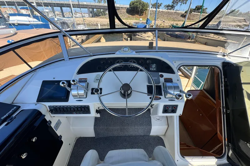  Yacht Photos Pics Pilothouse of 2006 Meridian 490 yacht with steering wheel, controls, and navigation equipment.
