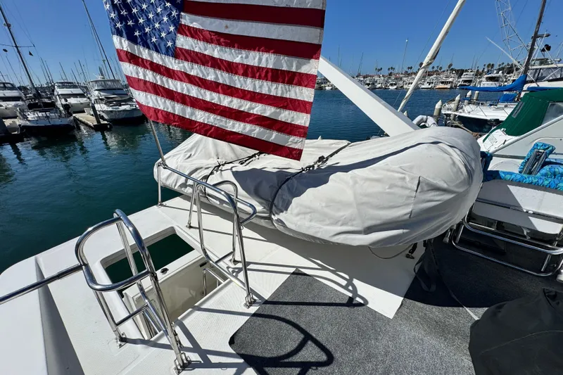  Yacht Photos Pics 2006 Meridian 490 Pilothouse yacht with American flag, docked in marina.