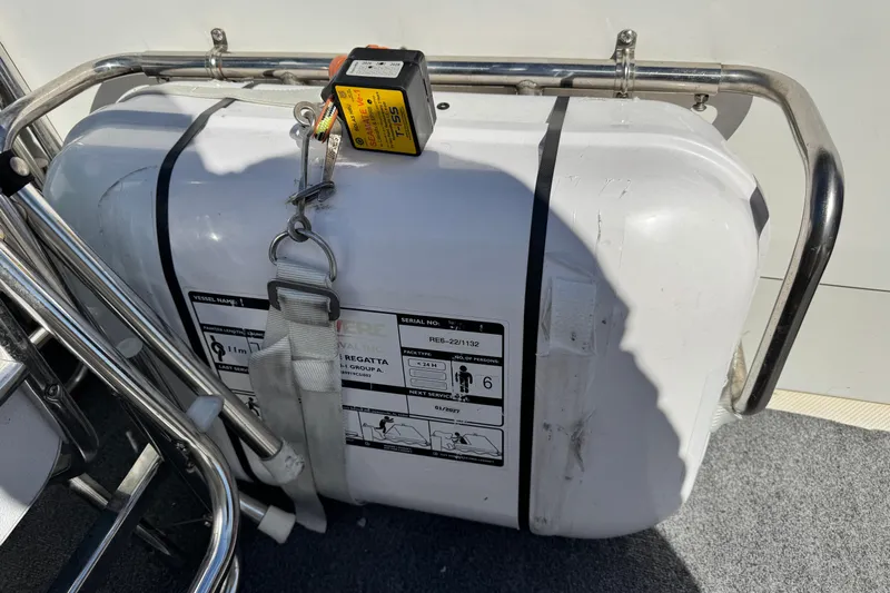  Yacht Photos Pics Life raft on 2006 Meridian 490 Pilothouse, secured with metal frame and straps.