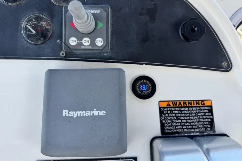  Yacht Photos Pics Control panel of a 2006 Meridian 490 Pilothouse with Raymarine equipment and warning label.