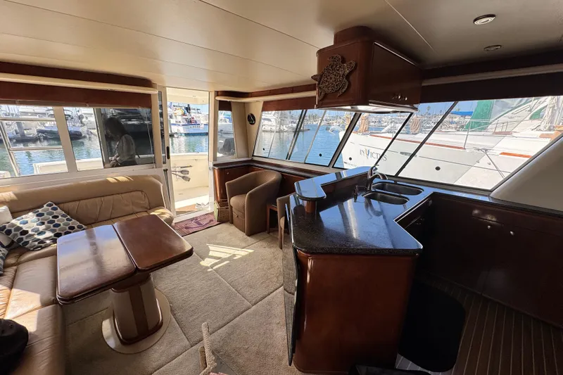  Yacht Photos Pics Luxurious interior of a 2006 Meridian 490 Pilothouse yacht with elegant furnishings and marina view.