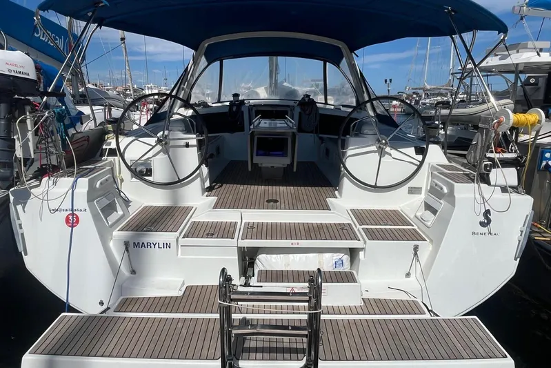 Marylin Yacht Photos Pics 2018 Beneteau Oceanis 48 yacht with dual steering wheels, docked at a marina.