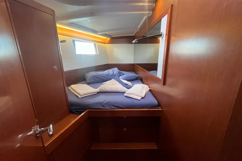 Marylin Yacht Photos Pics Cozy cabin interior of 2018 Beneteau Oceanis 48 yacht with wooden finish and comfortable bedding.
