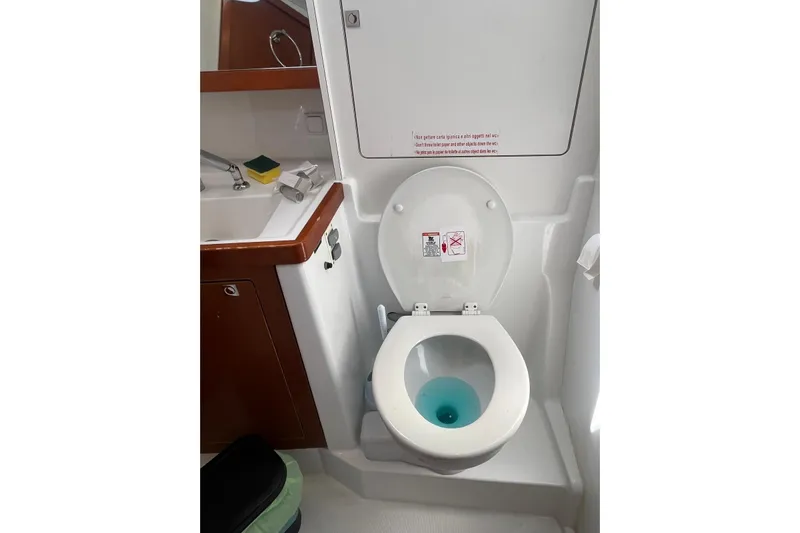 Marylin Yacht Photos Pics Bathroom of 2018 Beneteau Oceanis 48 yacht with toilet and sink.