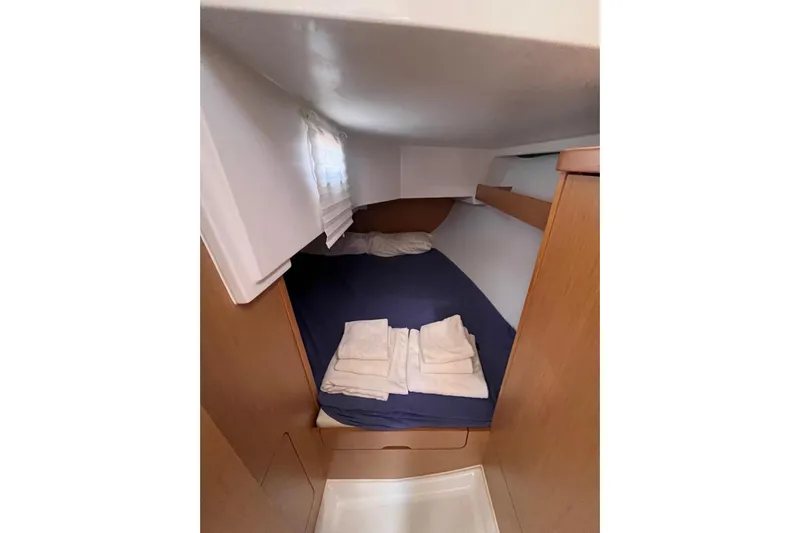 Marylin Yacht Photos Pics Cozy cabin interior of 2018 Beneteau Oceanis 48 sailboat with bed and linens.