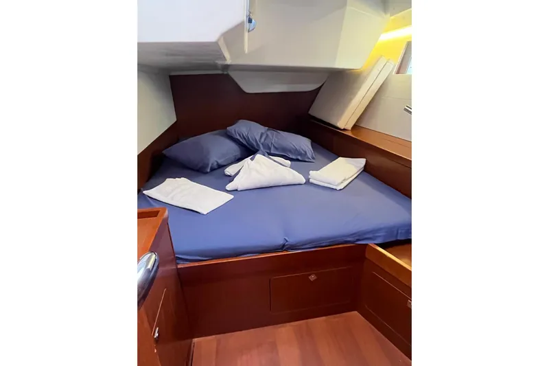 Marylin Yacht Photos Pics Cozy cabin interior of 2018 Beneteau Oceanis 48 with neatly arranged bedding.