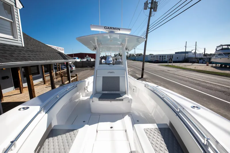  Yacht Photos Pics 2023 Invincible 33 Open Fisherman boat docked near a marina.