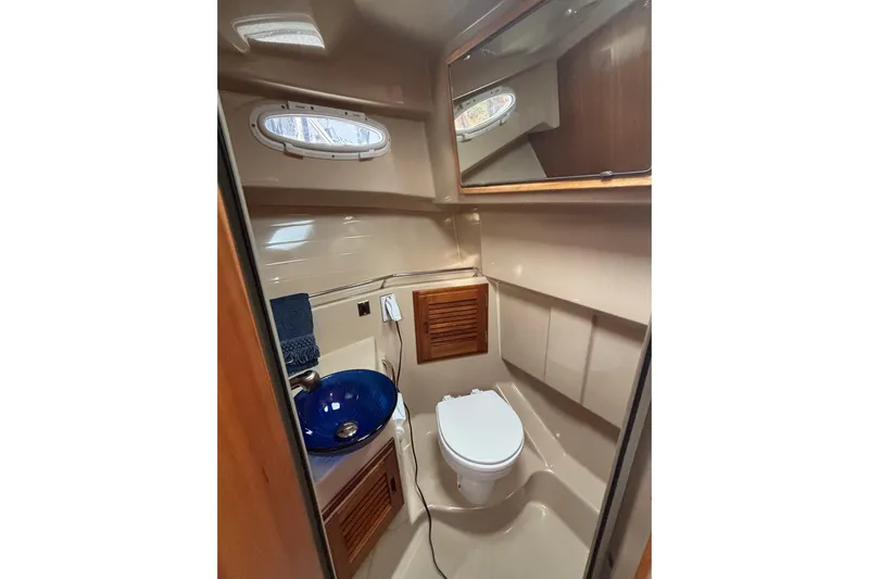 "salt Shaker" Yacht Photos Pics 2013 Cutwater C-28 boat bathroom with blue sink, toilet, and mirror.