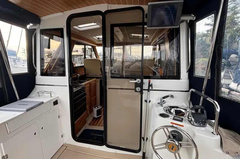 "salt Shaker" Yacht Photos Pics Interior view of 2013 Cutwater C-28 boat with helm and cabin entrance.