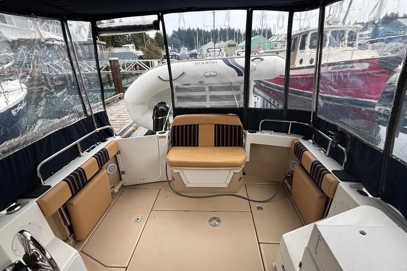 "salt Shaker" Yacht Photos Pics 2013 Cutwater C-28 boat interior with tan seating and clear enclosure at dock.