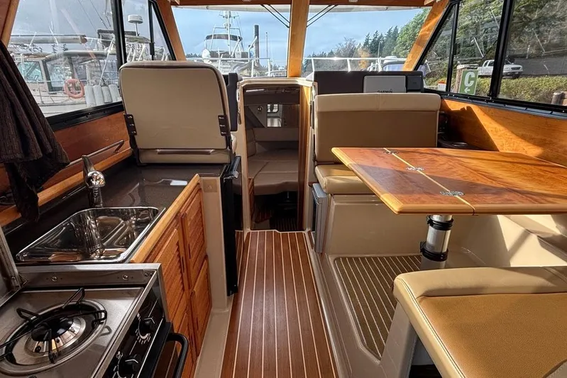 "salt Shaker" Yacht Photos Pics 2013 Cutwater C-28 boat interior with kitchen, seating, and wooden table.