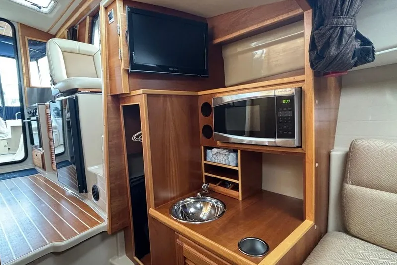 "salt Shaker" Yacht Photos Pics 2013 Cutwater C-28 interior with kitchenette, featuring microwave, sink, and TV.