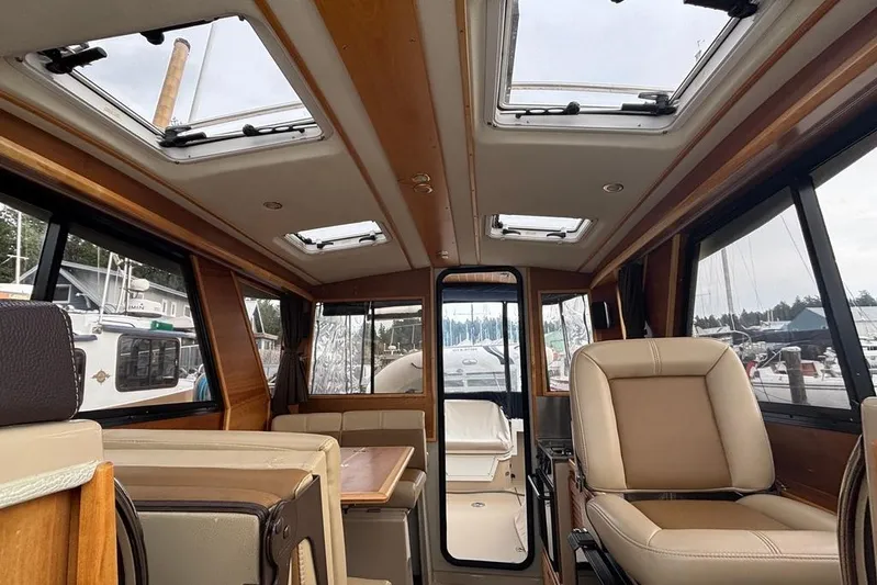 "salt Shaker" Yacht Photos Pics Interior of a 2013 Cutwater C-28 boat with skylights and beige seating.
