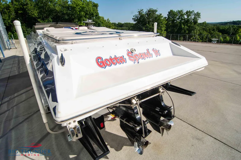  Yacht Photos Pics 2005 Fountain 42 Executioner speedboat with Gotta Speed It decal, docked on concrete.