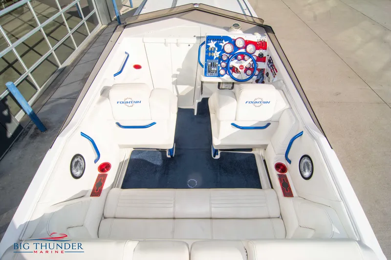  Yacht Photos Pics 2005 Fountain 42 Executioner boat interior with white and blue seating.