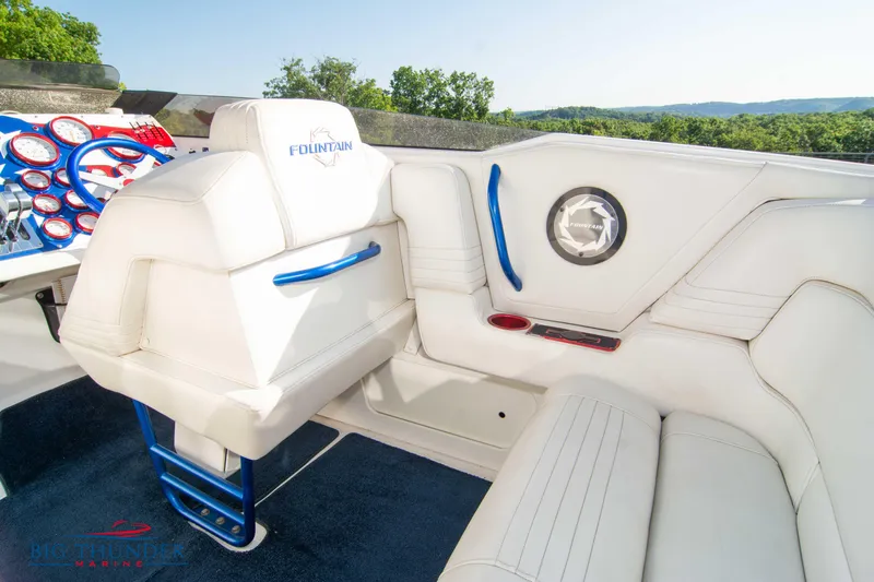  Yacht Photos Pics Interior of a 2005 Fountain 42 Executioner boat with white and blue seating.
