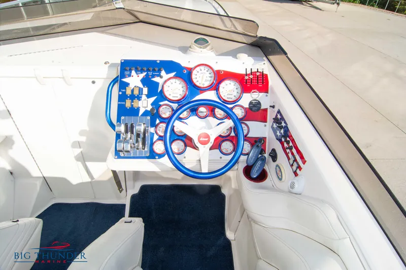  Yacht Photos Pics 2005 Fountain 42 Executioner boat cockpit with patriotic-themed dashboard and steering wheel.