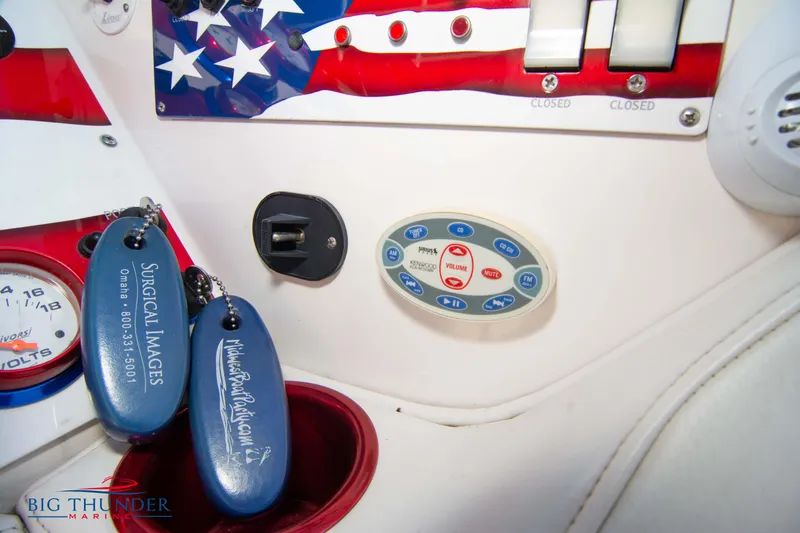 Yacht Photos Pics Control panel of a 2005 Fountain 42 Executioner boat with keychains and American flag design.