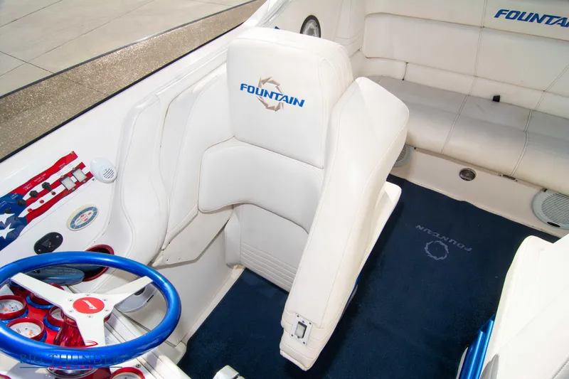  Yacht Photos Pics Interior of a 2005 Fountain 42 Executioner boat with white seating and blue accents.