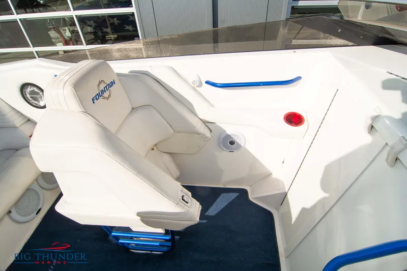  Yacht Photos Pics 2005 Fountain 42 Executioner boat interior with white seating and blue accents.