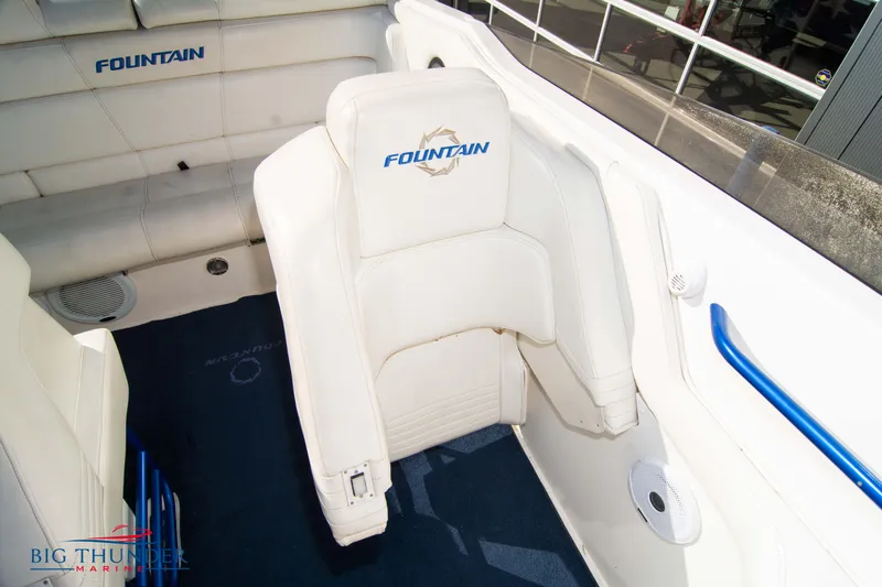  Yacht Photos Pics 2005 Fountain 42 Executioner boat interior with white seating and blue accents.