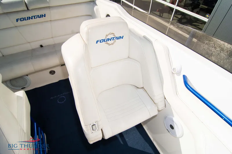  Yacht Photos Pics 2005 Fountain 42 Executioner boat interior with white seating and blue accents.