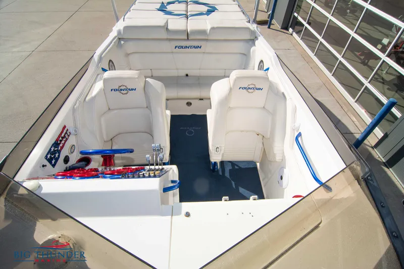  Yacht Photos Pics 2005 Fountain 42 Executioner boat interior with white seating and blue accents.