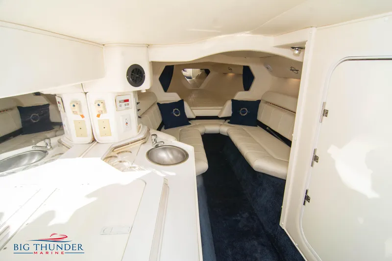  Yacht Photos Pics Interior of 2005 Fountain 42 Executioner boat with white leather seating and kitchenette.