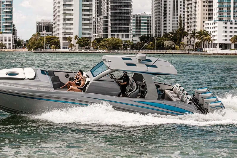  Yacht Photos Pics 2027 Deep Impact 399 Fwd Cabin cruising near city skyline, featuring sleek design and powerful engines.