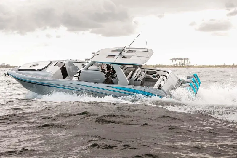  Yacht Photos Pics 2027 Deep Impact 399 Fwd Cabin boat navigating choppy waters under cloudy skies.