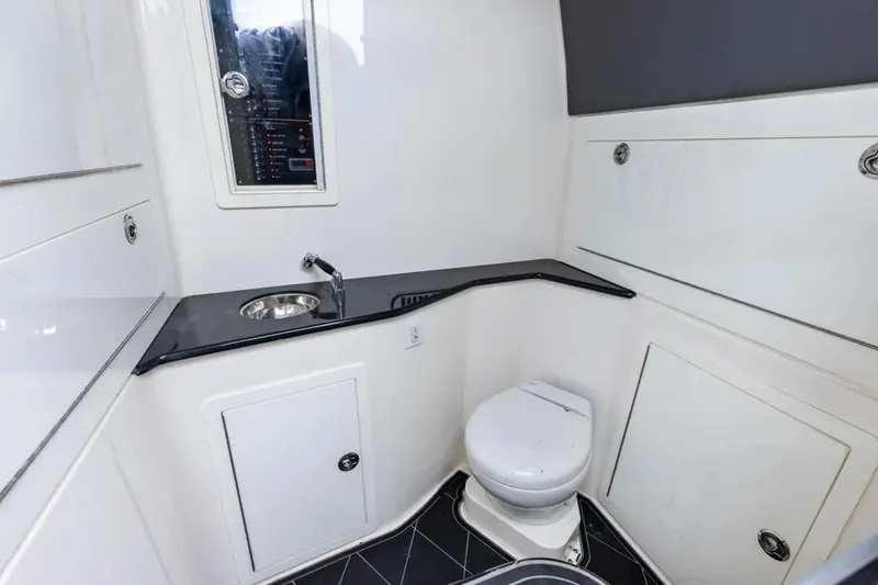  Yacht Photos Pics Modern bathroom in 2027 Deep Impact 399 Fwd Cabin boat, featuring sink and toilet.