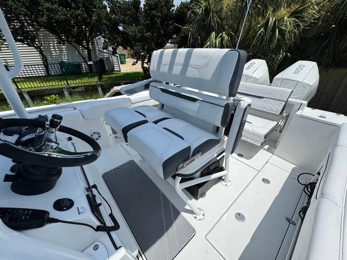  Yacht Photos Pics 2021 Blackfin 252 CC boat interior with modern seating and steering wheel.