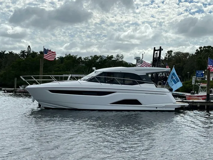Inventory Clearance Yacht Photos Pics 2023 Bavaria R40 Coupe yacht docked, surrounded by flags, under a cloudy sky.